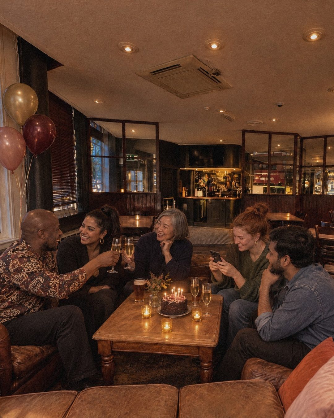 A cosy private celebration around the candlelit cake